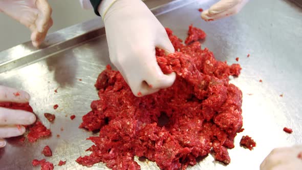 Hands of butchers preparing meat ball from minced meat