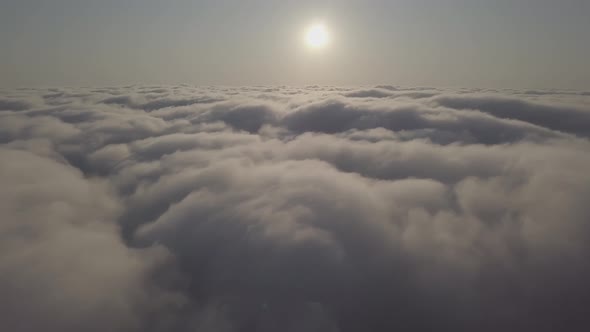 View From a Drone on a Sea of Clouds to the Horizon at Dawn