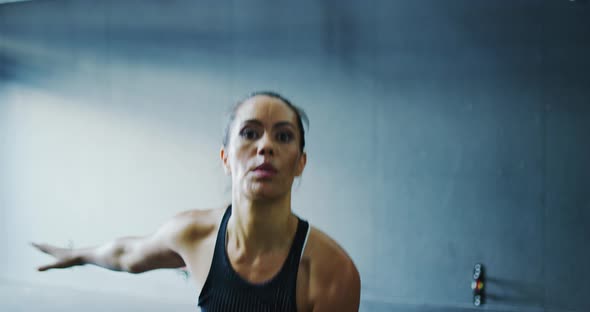 Woman Exercising with Kettlebells