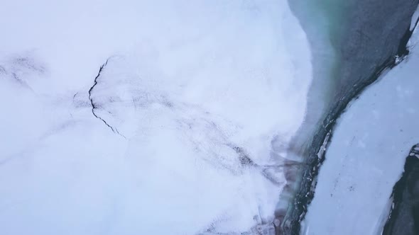 Drone rises up over a frozen lake in Switzerland.