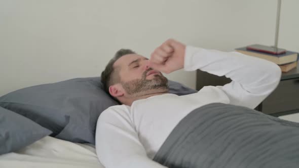 Man Coughing While Sleeping in Bed