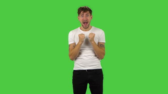 Confident Guy with Shocked Surprised Wow Face Expression Is Rejoicing. Green Screen