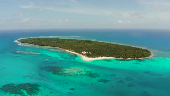 Tropical Daco Island with a Sandy Beach and Tourists