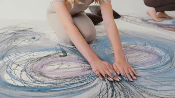 A Talented Artist Works on an Abstract Pastel Painting Using Her Hands To Draw