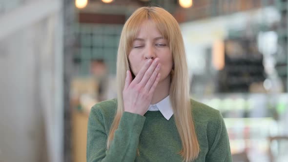 Portrait of Young Woman Giving Flying Kiss By Hands