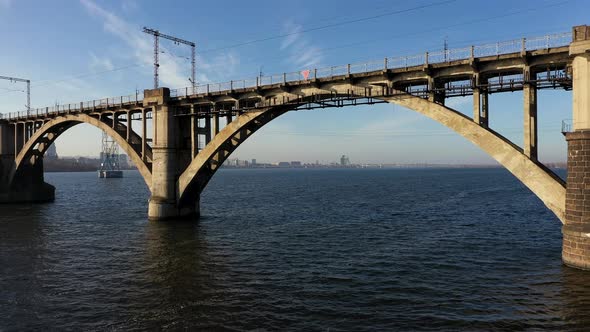 Aerial View Under the Old Arch Railway Bridge in Dnipro City