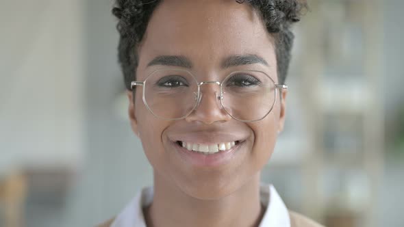 Portrait of Smiling Young African Girl with Glasses