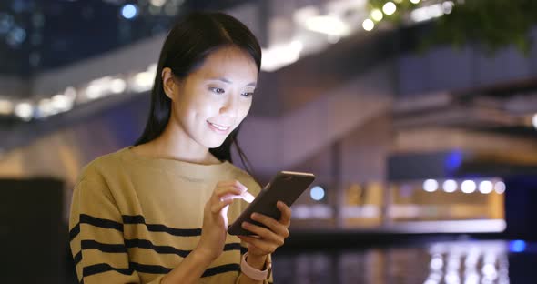 Woman use of cellphone at night