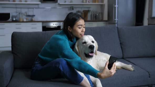 Smiling Cute Indian Woman with Dog Making Selfie