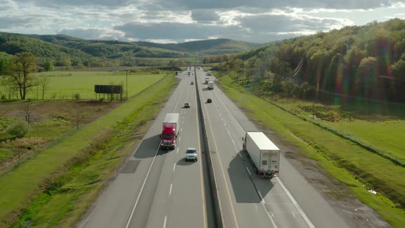 Aerial Drone Wide View of Flight Over the Highway with Many Cars and Trucks