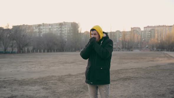 Young Frozen Man in Yellow Hood and Black Jacket