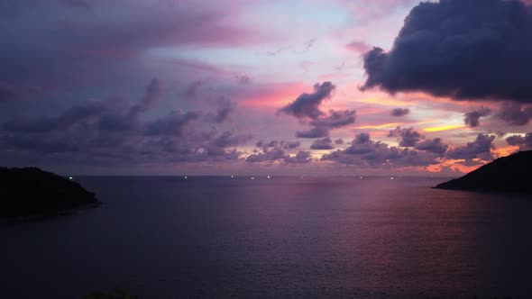 locked wide panoramic time lapse shot of a tropical sunset after a rainy monsoon day with golde, pur