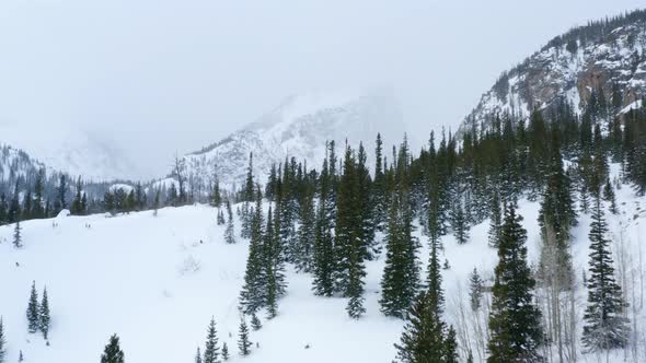 Aerial forward crane up shot of a snowy mountain