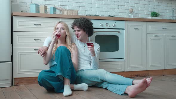 Happy Young Teens Couple Sitting on Warm Heated Floor