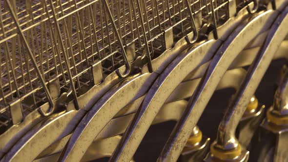 Old steel shopping carts stacked together in a long endless, looped row. 4K HD