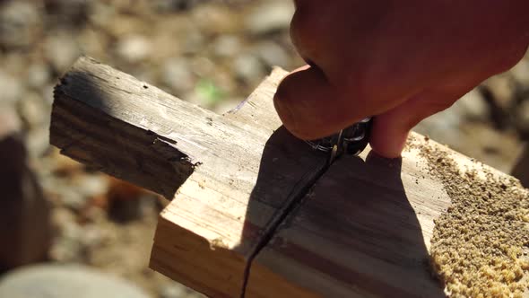 Using a Swiss Knife a Man Saws Wood Planks and Makes a Handle Outdoor Survival and Camping Fun in