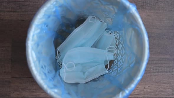 Dispose the Medical Face Mask and Gloves in a Bin, Top View