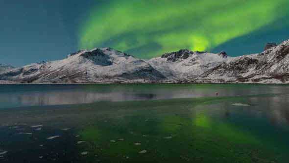 Aurora over the frozen lake in Lofoten, Norway.the Earth with green roof.