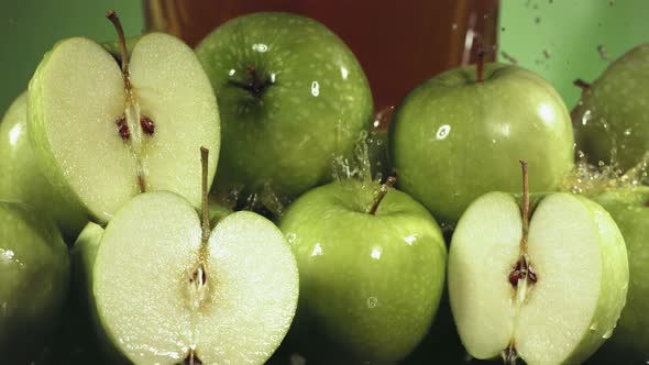 Slow Motion Shot of Green Apple Juice Splashing Through Apple Slices