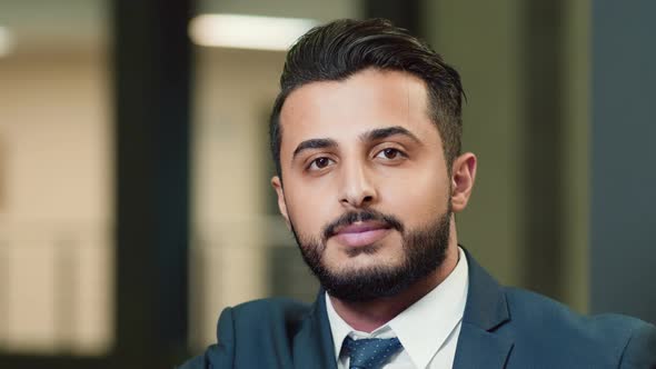 Portrait of successful Arabian businessman leaning on railing