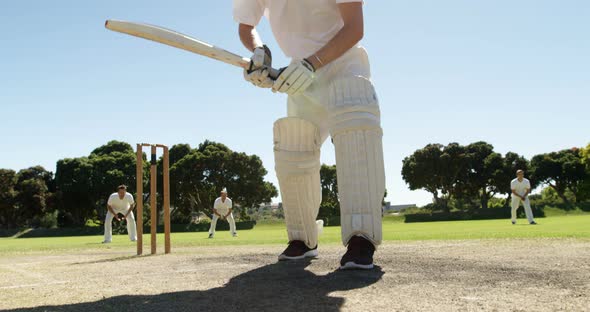 Batsman playing straight drive during cricket match