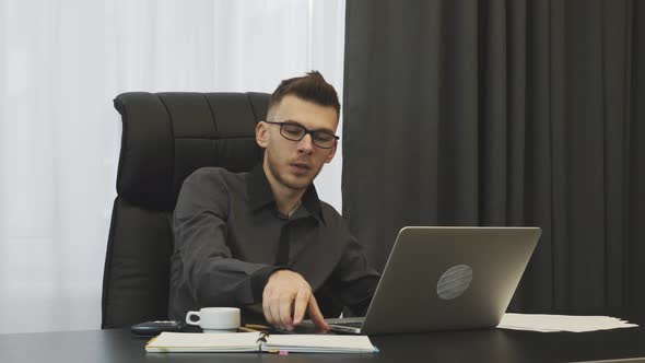 Man sleeping at working place, almost falling down from office desk. Business concept