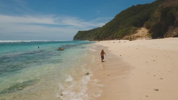 Child Runs Along the Beach