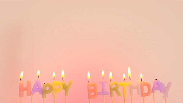 Happy birthday. Birthday burning candles on a pink background