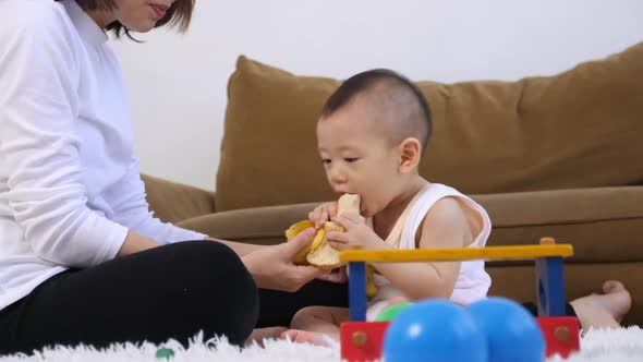 Young mother with her baby spending time together at home.