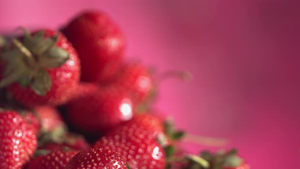 Ripe Juicy Strawberry is Rolling Above Many Strawberries