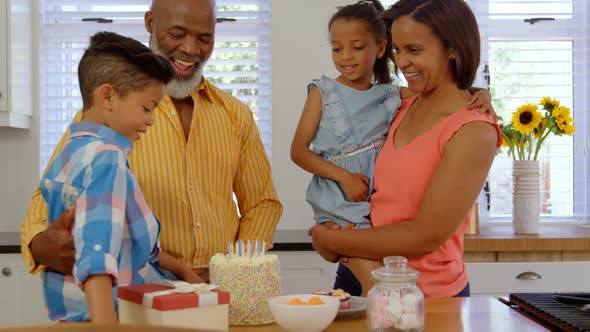 Front view of black family celebrating birthday in kitchen of comfortable home 4k