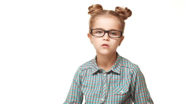 Small Girl Caucasian Kid in Plaid Shirt and Hair Buns Wearing Glasses Posing Making Faces on White