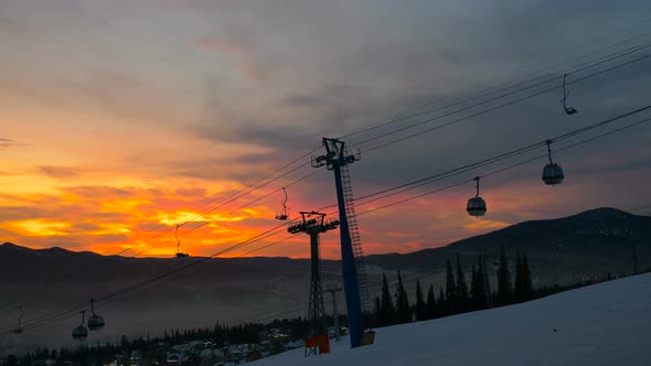 Poma Lift with Cabins Moving Along Cables at Bright Sunset