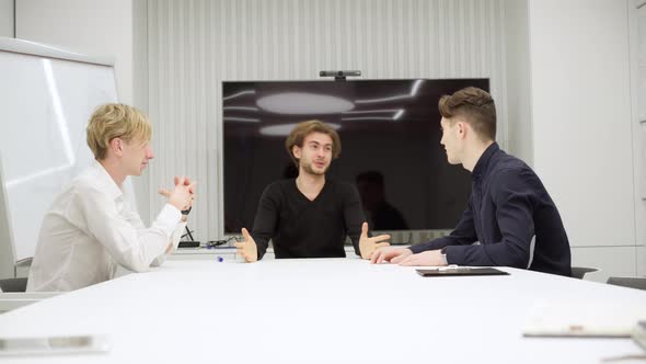 Nervous Stressed Man Hitting Table and Talking To Colleagues Arguing on Startup Project