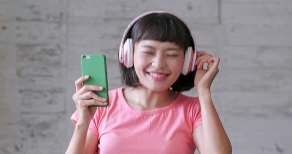 Young asian woman feeling happy and dancing at home