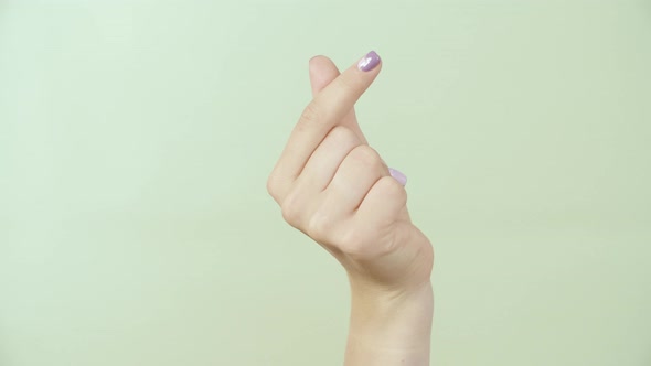 Female Hand Giving Thumbs Up Green Background