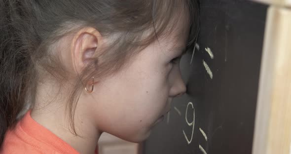 Child Stay By Blackboard on Lesson