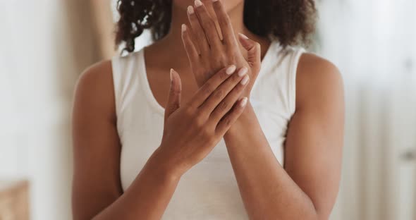 Black Woman Applying Hand Cream, Making Daily Beauty Treatment at Home, Close Up, Slow Motion