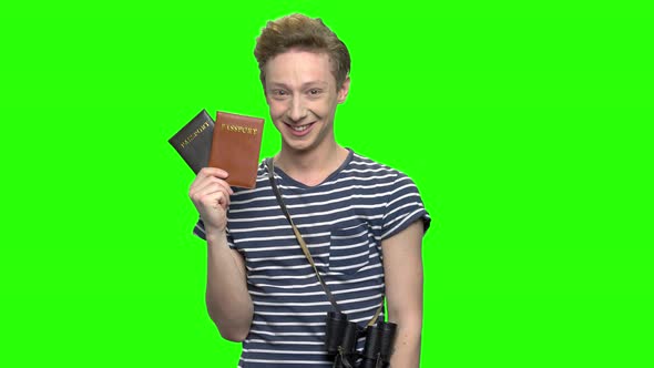 Young Tourist Boy with Shows Passports