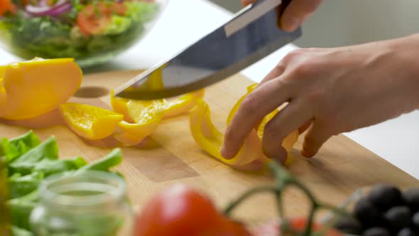 Young Woman Chopping Pepper at Home