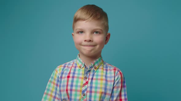 Happy Preschool Boy Receiving Paper Bag with Food Standing on Blue Background