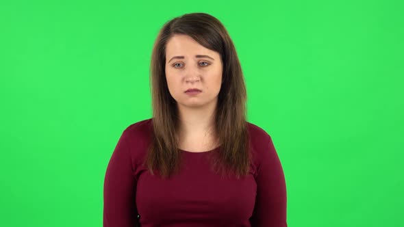 Portrait of Upset Girl Shrugging and Shaking Her Head Negatively . Green Screen
