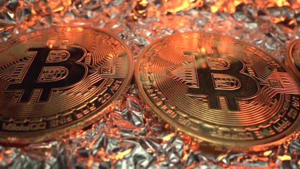 Bitcoin in Macro Shot. Many Crypto Coins on Reflect Surface with Gold Light on It. Blockchain