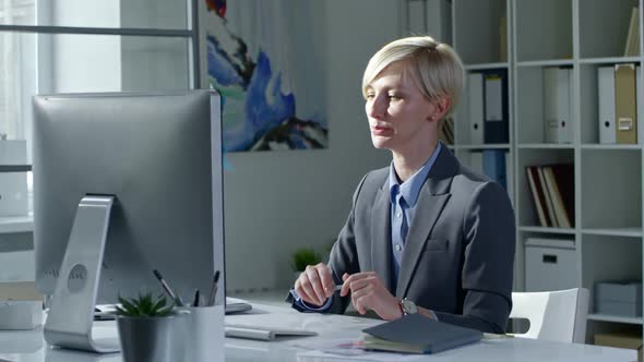 Blonde Business Lady Video Conferencing on Computer