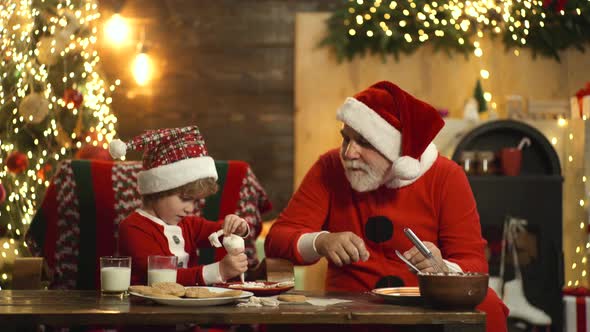 Stylish Bearded Santa Claus Bake Christmas Ginger Cookies for Xmas. Santa Child Helper Prepare Xmas