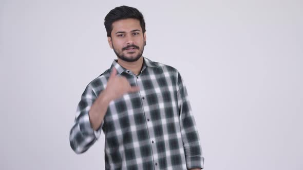 Young Happy Bearded Indian Man with Call Me Gesture