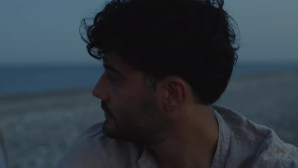 Young Couple at the Bonfire on the Beach