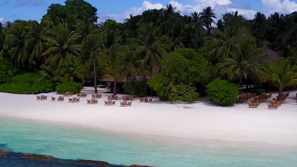 Aerial drone scenery of shore beach journey by blue water with sand background