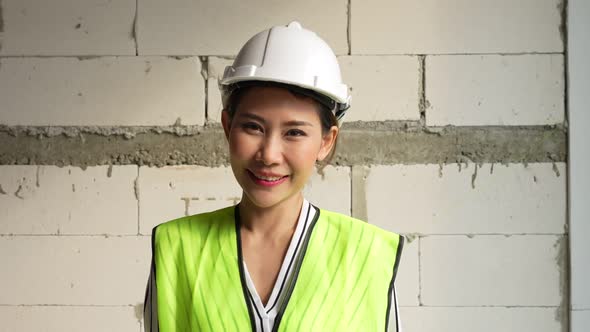 Portrait of asian female industrial worker or Contractor on construction site. Asian Business People