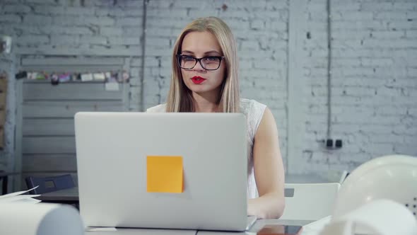 Young Businesswoman Talking Watching Laptop Webcam While Working on Startup Project in Office